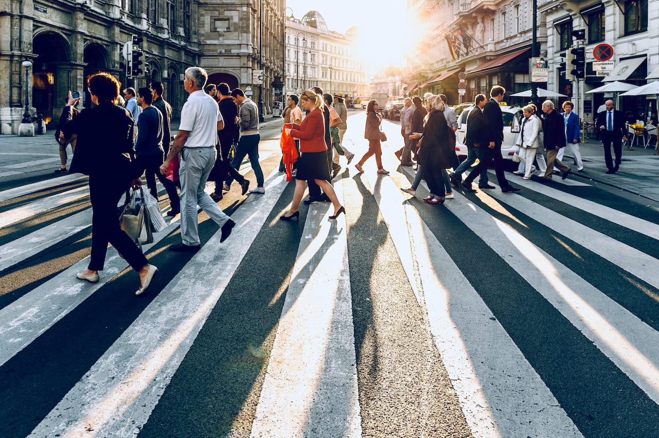 Photograph of a group of pedestrians crossing the street.