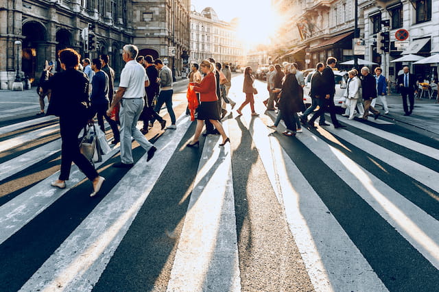 Photograph of a group of pedestrians crossing the street.
