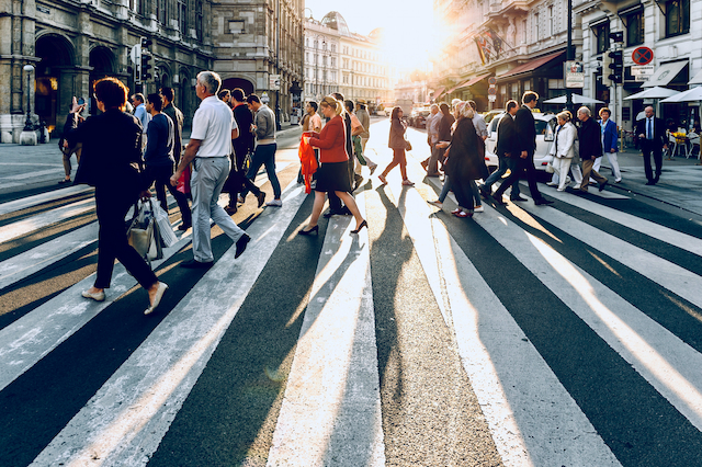 Photograph of a group of pedestrians crossing the street.